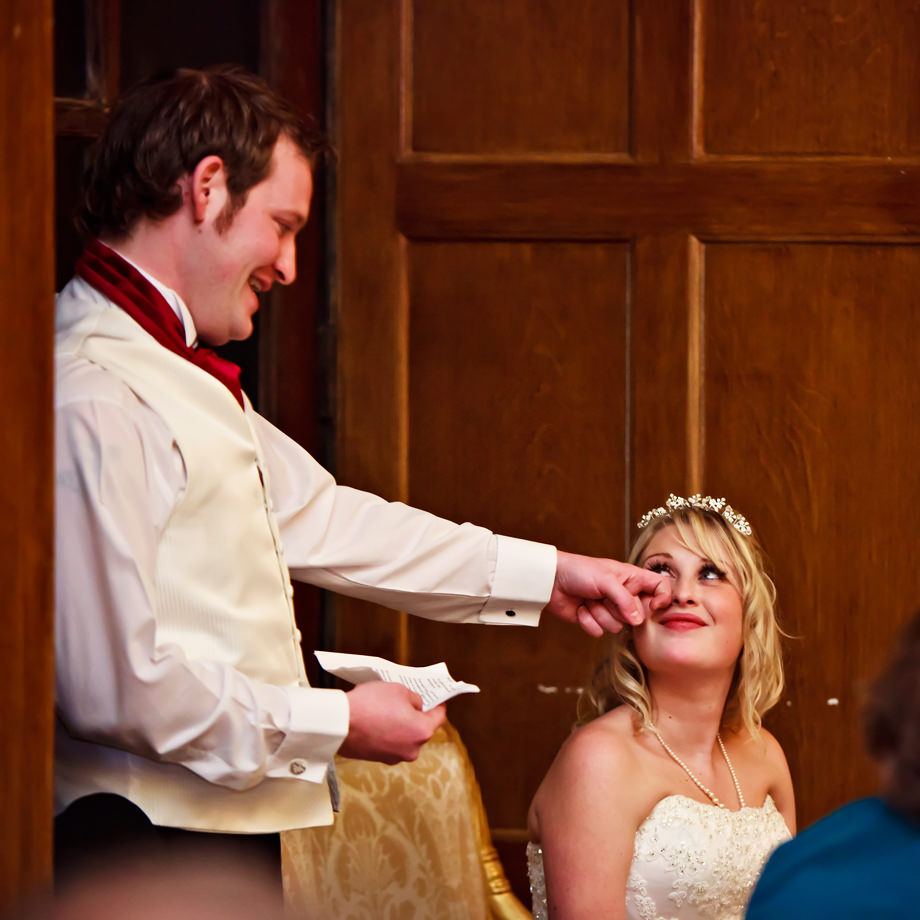 the groom touches his brides face during his speech